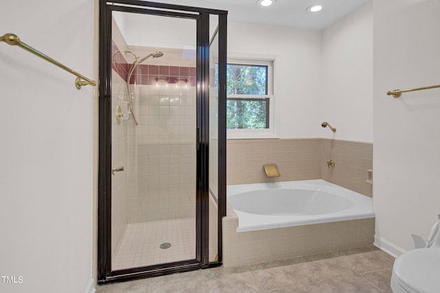 bathroom featuring shower with separate bathtub, tile patterned floors, and toilet