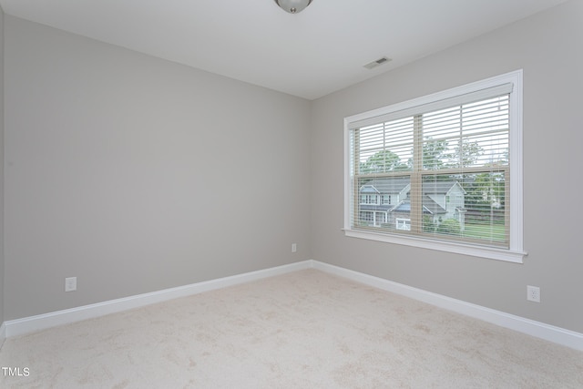 unfurnished room featuring light carpet