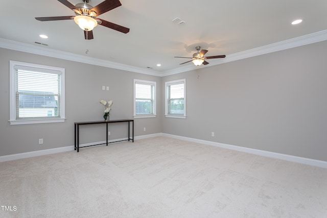 unfurnished room featuring visible vents, crown molding, light carpet, and baseboards