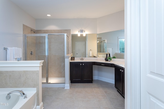 bathroom featuring tile patterned floors, vanity, and shower with separate bathtub