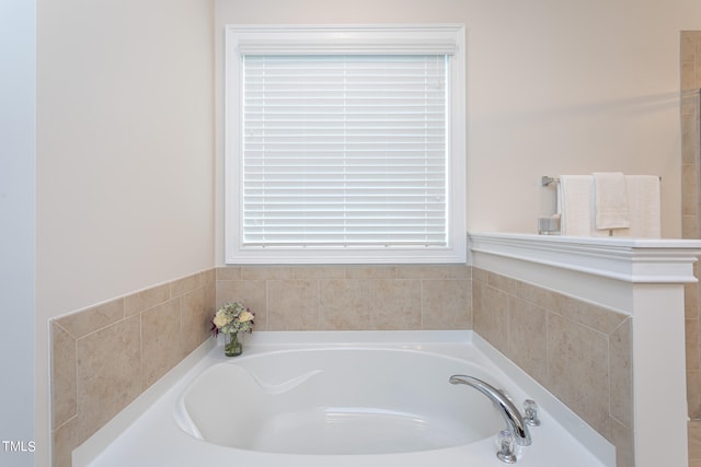 bathroom with a relaxing tiled tub