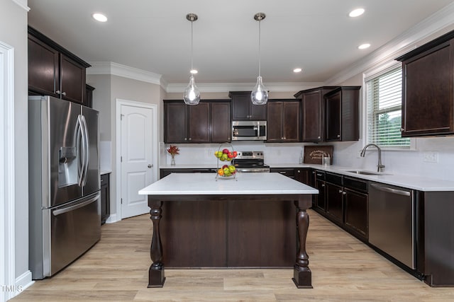 kitchen featuring a kitchen bar, dark brown cabinets, stainless steel appliances, pendant lighting, and light hardwood / wood-style floors