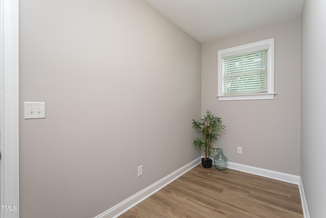 empty room with light wood-type flooring and baseboards