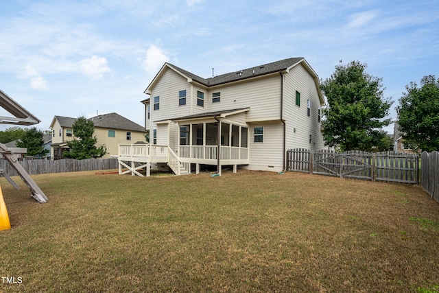 back of house with a yard, a sunroom, and a wooden deck