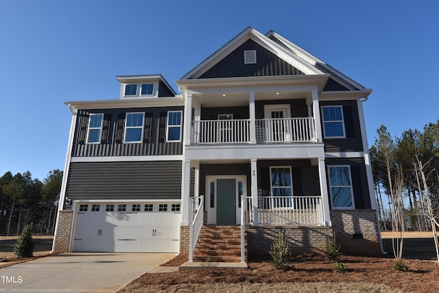 view of front of home featuring a balcony and a garage