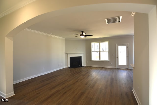 unfurnished living room featuring ceiling fan, crown molding, and dark hardwood / wood-style flooring