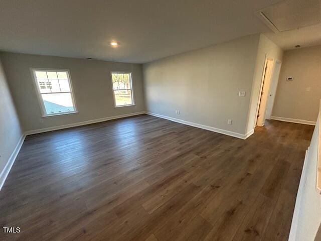 unfurnished room with dark wood-type flooring