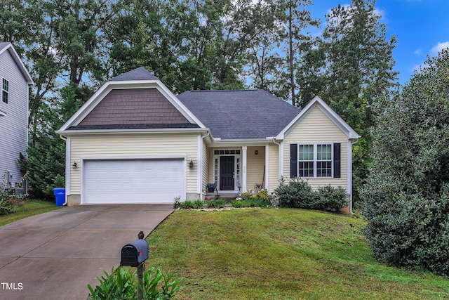 view of front of property with a front yard and a garage