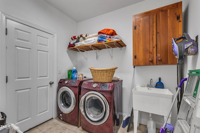 laundry room featuring cabinets, separate washer and dryer, and light tile patterned flooring