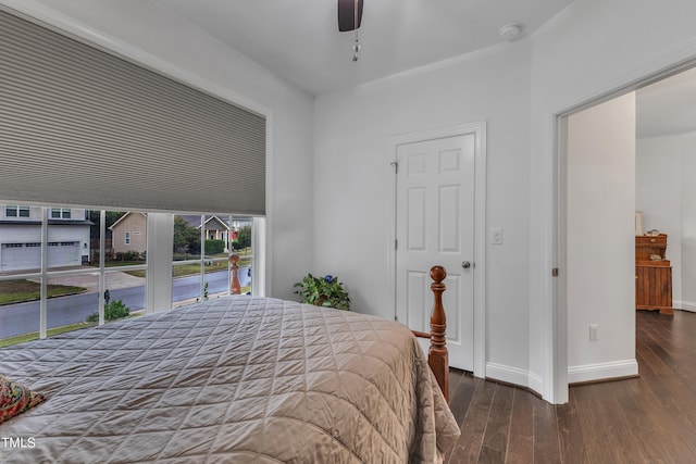 bedroom featuring ceiling fan, access to exterior, and dark wood-type flooring