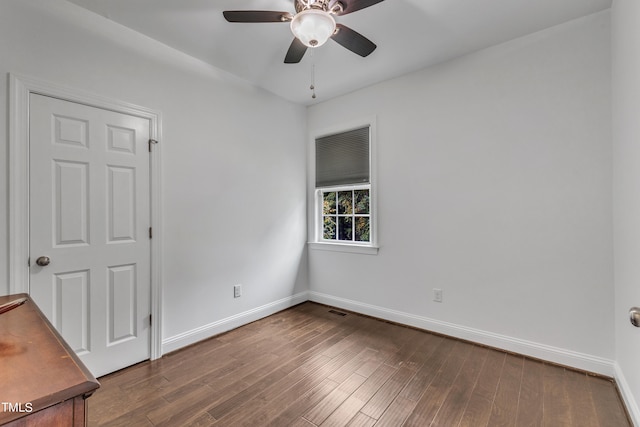 spare room featuring wood-type flooring and ceiling fan