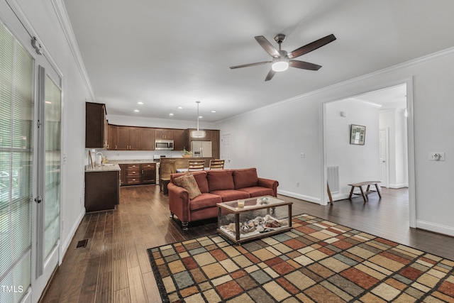 living room featuring ceiling fan, crown molding, and dark wood-type flooring