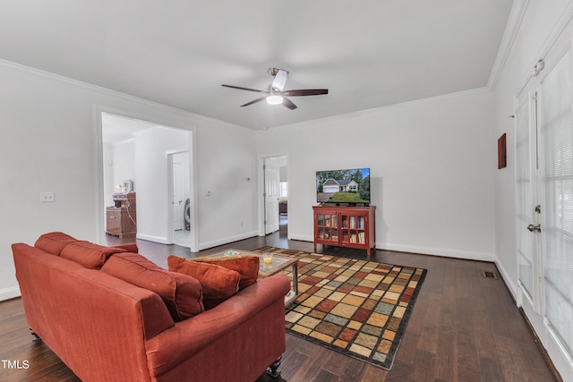 living room with ornamental molding, washer / dryer, ceiling fan, and dark hardwood / wood-style floors