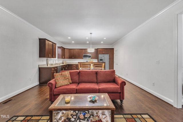 living room featuring ornamental molding, dark hardwood / wood-style floors, and sink