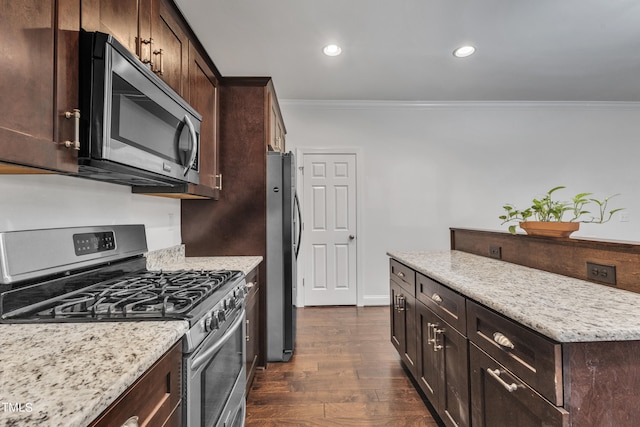 kitchen with light stone counters, dark wood-type flooring, appliances with stainless steel finishes, dark brown cabinetry, and ornamental molding