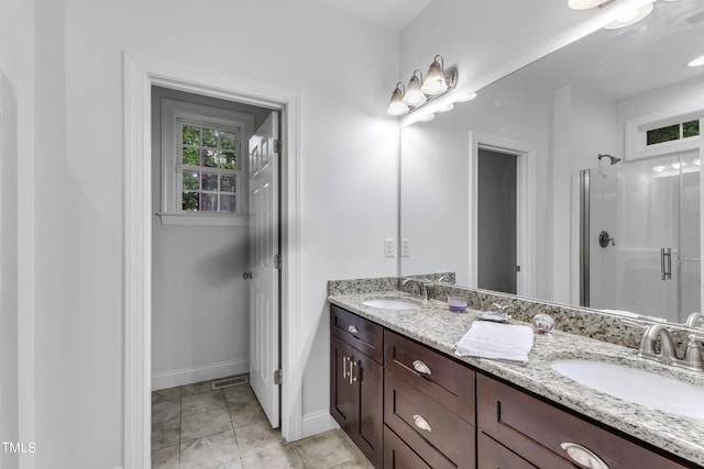 bathroom featuring tile patterned flooring, walk in shower, and vanity