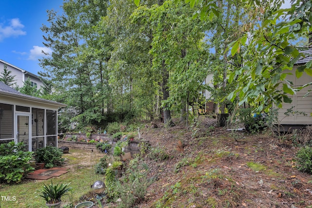 view of yard featuring a sunroom