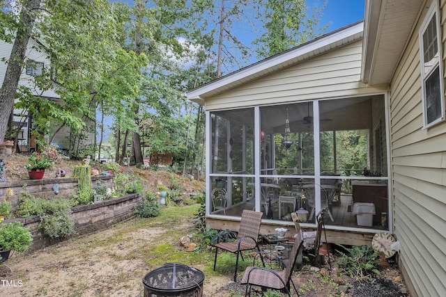 view of yard featuring a sunroom and a fire pit