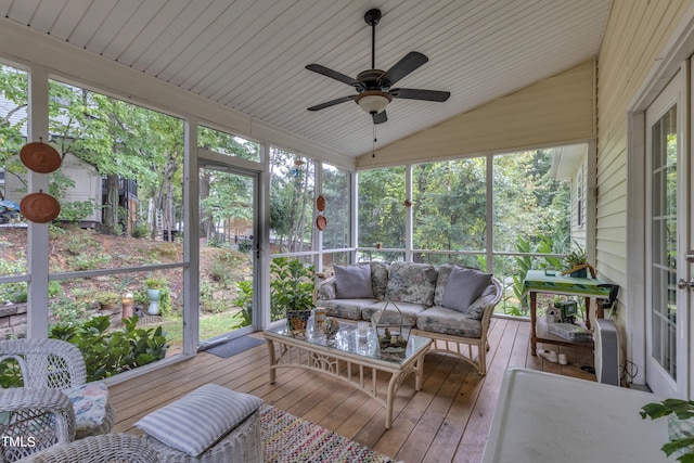 sunroom featuring vaulted ceiling and ceiling fan