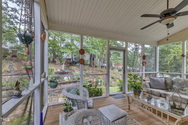 sunroom featuring ceiling fan, lofted ceiling, wood ceiling, and a healthy amount of sunlight