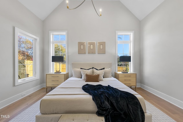 701 Dartmouth Rd, Raleigh, NC 27609 - bedroom with wood finished floors, high vaulted ceiling, and baseboards