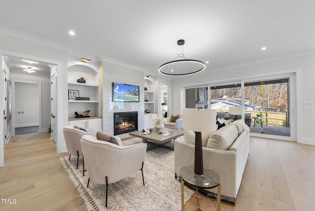 701 Dartmouth Rd, Raleigh, NC 27609 - living area featuring ornamental molding, light wood-style floors, baseboards, a premium fireplace, and built in features
