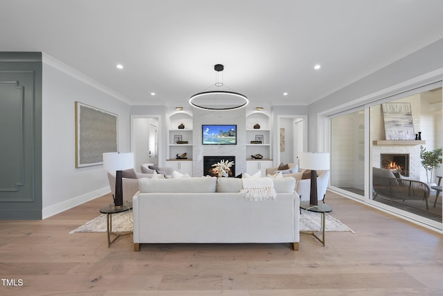 701 Dartmouth Rd, Raleigh, NC 27609 - living area featuring a lit fireplace, ornamental molding, baseboards, built in features, and recessed lighting