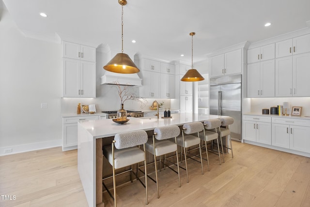 701 Dartmouth Rd, Raleigh, NC 27609 - kitchen featuring built in fridge, light wood-style flooring, light countertops, white cabinetry, and recessed lighting