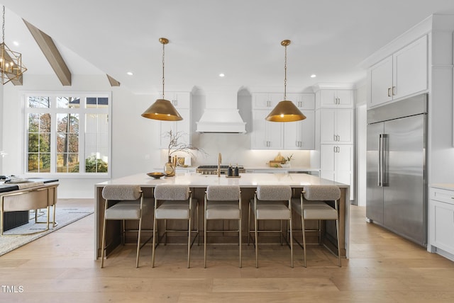 701 Dartmouth Rd, Raleigh, NC 27609 - kitchen with stainless steel built in refrigerator, premium range hood, white cabinetry, recessed lighting, and light countertops