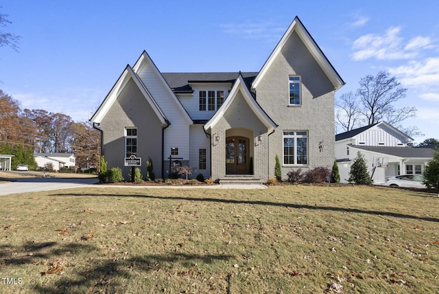 view of front of home with a front yard and french doors