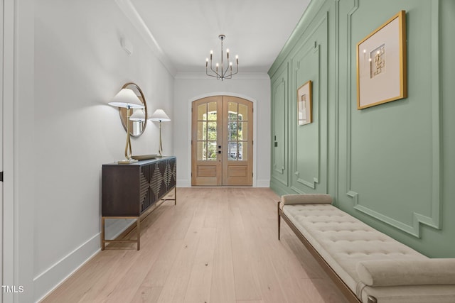 701 Dartmouth Rd, Raleigh, NC 27609 - foyer entrance featuring a chandelier, light wood-style floors, french doors, and ornamental molding
