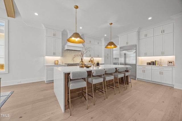 701 Dartmouth Rd, Raleigh, NC 27609 - kitchen with built in fridge, light wood finished floors, white cabinets, and recessed lighting
