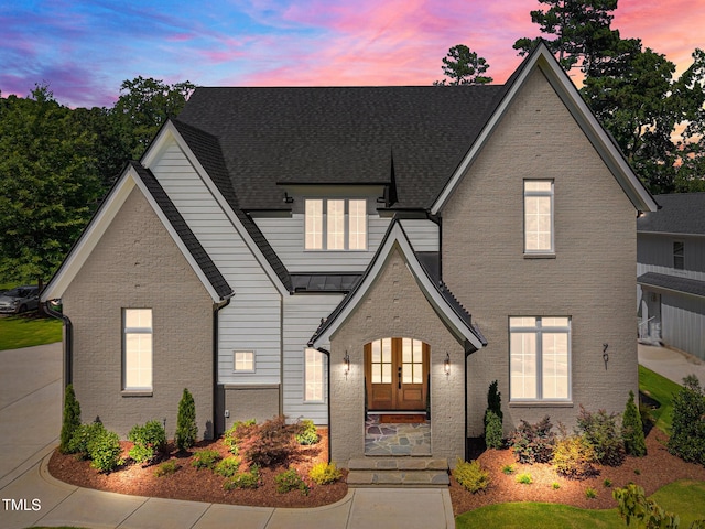 701 Dartmouth Rd, Raleigh, NC 27609 - view of front of home with french doors, a standing seam roof, and brick siding