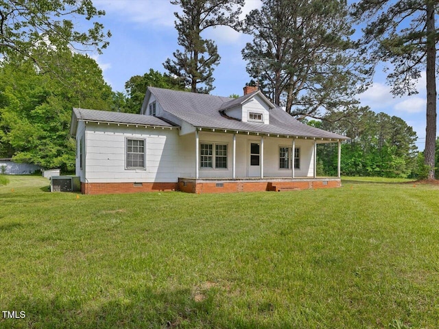 rear view of house featuring covered porch, a chimney, central AC unit, crawl space, and a lawn