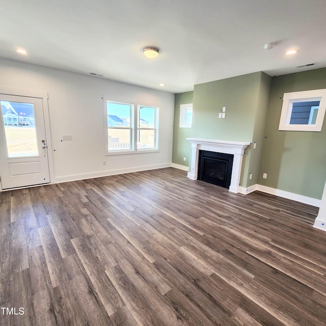 unfurnished living room featuring dark hardwood / wood-style floors