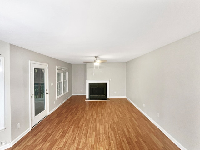 unfurnished living room featuring light hardwood / wood-style flooring and ceiling fan