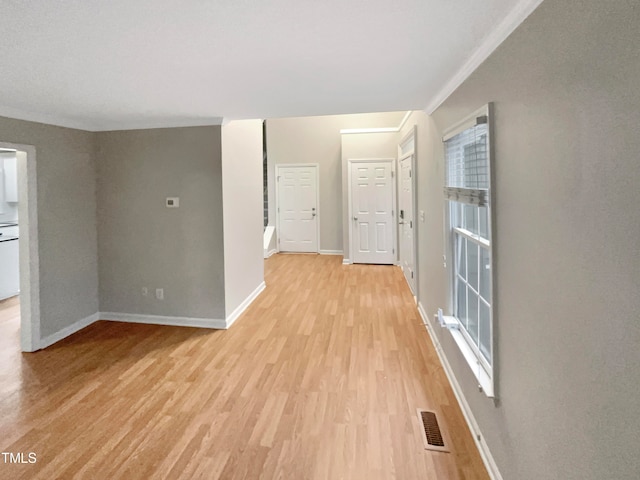 interior space with light hardwood / wood-style flooring and crown molding