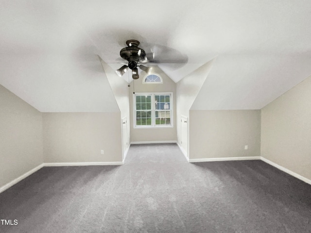 additional living space with light carpet, vaulted ceiling, and ceiling fan