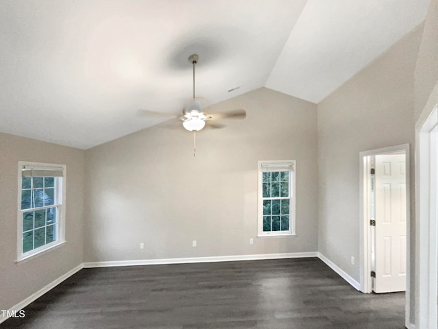 spare room featuring lofted ceiling, dark hardwood / wood-style floors, and ceiling fan