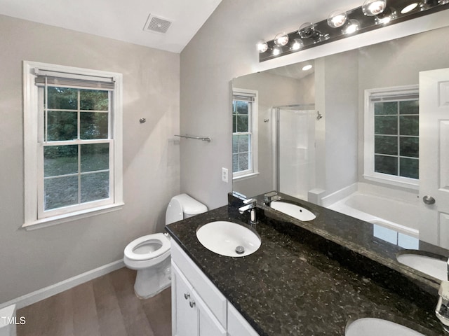 full bathroom with hardwood / wood-style floors, independent shower and bath, vanity, and toilet