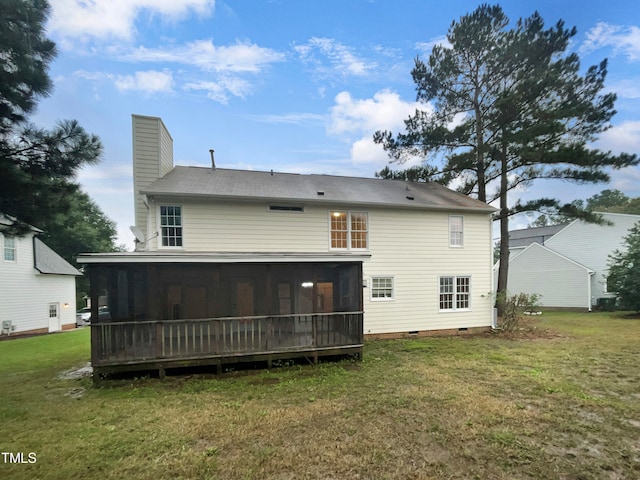 back of house with a sunroom and a yard