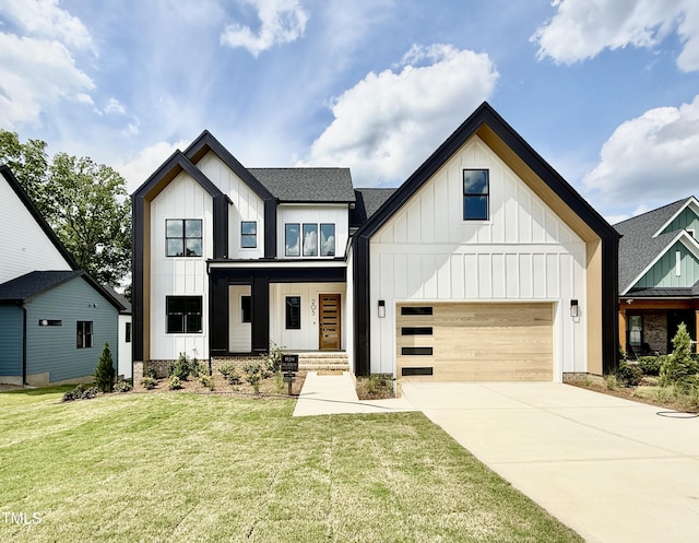 205 Red Cardinal Ct, Youngsville, NC 27596 - modern farmhouse with a garage, concrete driveway, board and batten siding, a shingled roof, and a front lawn