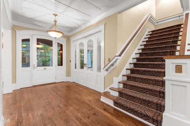 entryway with crown molding, french doors, and wood-type flooring