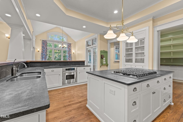 kitchen featuring sink, hanging light fixtures, light hardwood / wood-style flooring, white cabinets, and appliances with stainless steel finishes