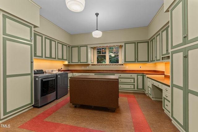 3105 Cone Manor Ln, Raleigh, NC 27613 - kitchen with green cabinetry, washing machine and clothes dryer, dark flooring, pendant lighting, and crown molding