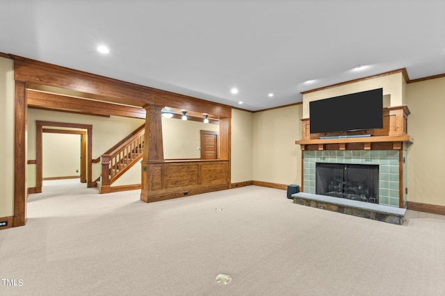 unfurnished living room with carpet flooring, a fireplace, and crown molding