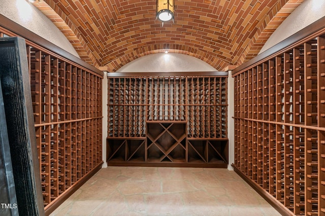 wine cellar with brick ceiling and lofted ceiling