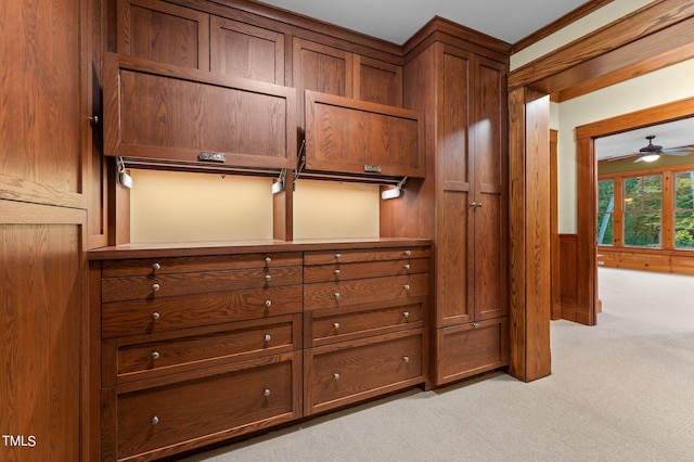 spacious closet featuring ceiling fan and light colored carpet