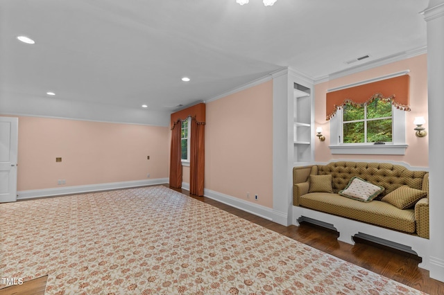 living room featuring crown molding, plenty of natural light, and dark wood-type flooring