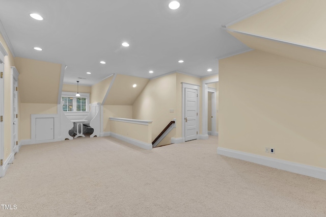 bonus room with light colored carpet and lofted ceiling